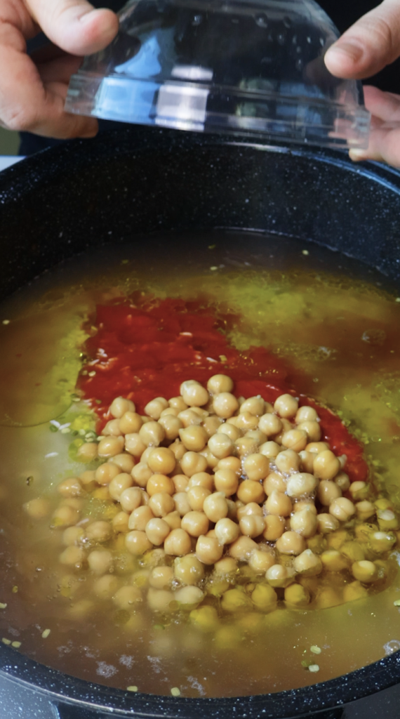 1. Add rinsed rice and mung beans to a large Dutch oven, then add water, beef broth, tomato sauce, oil, chickpeas, seasonings, and cilantro. 